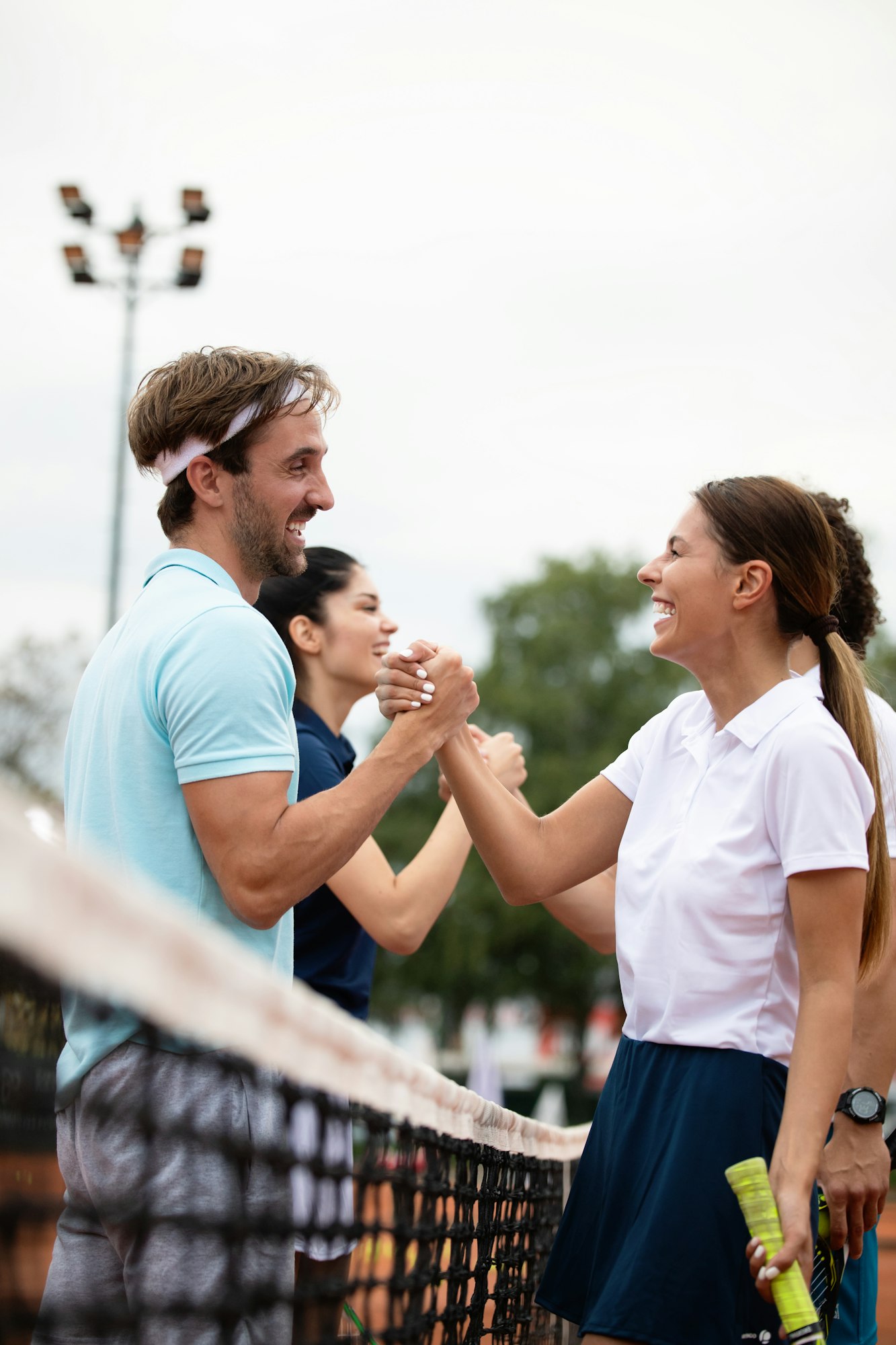 Happy group of tennis players at the tennis court