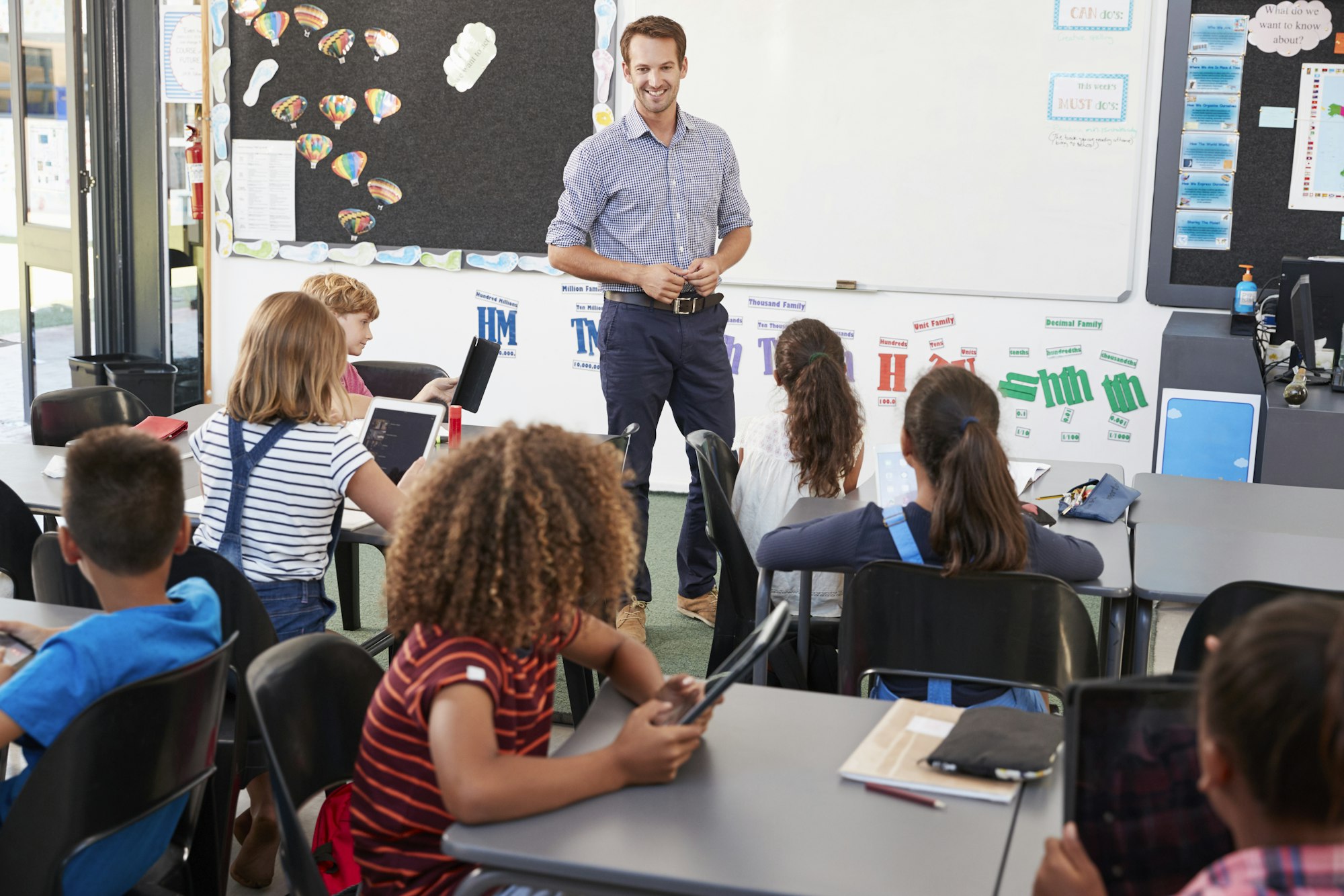 Teacher standing in front of elementary school class